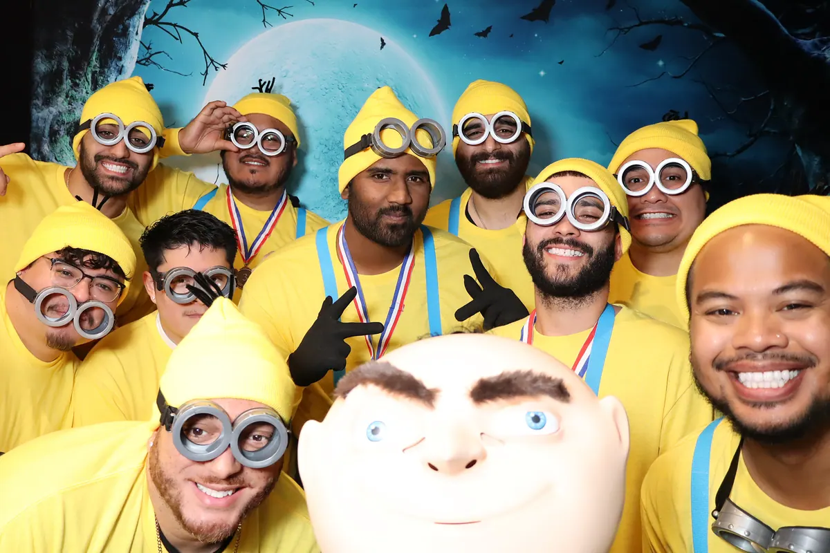 Costumed group photographed with a themed digital background