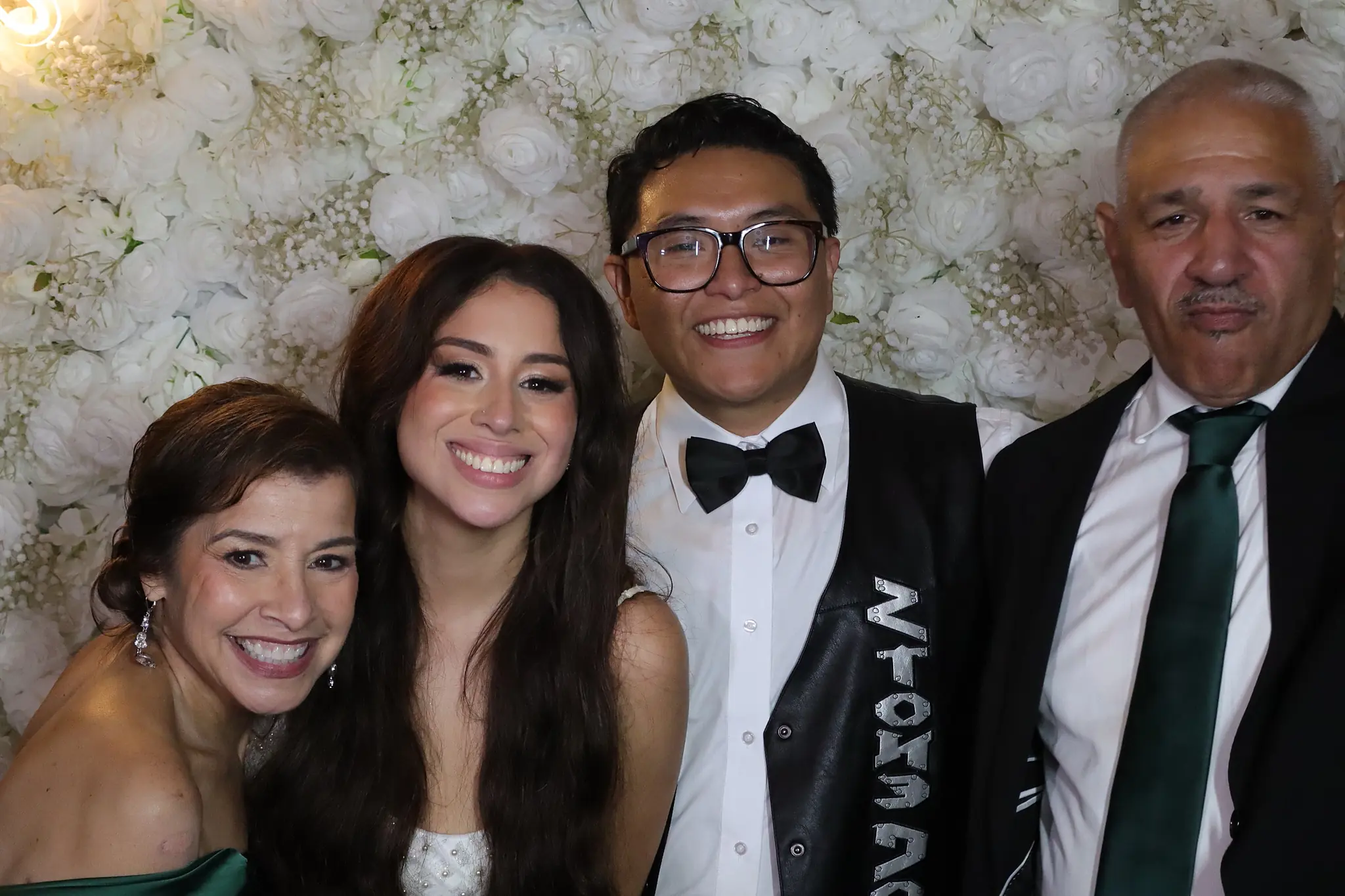Bride and groom photographed with family at their wedding by Images & Creations