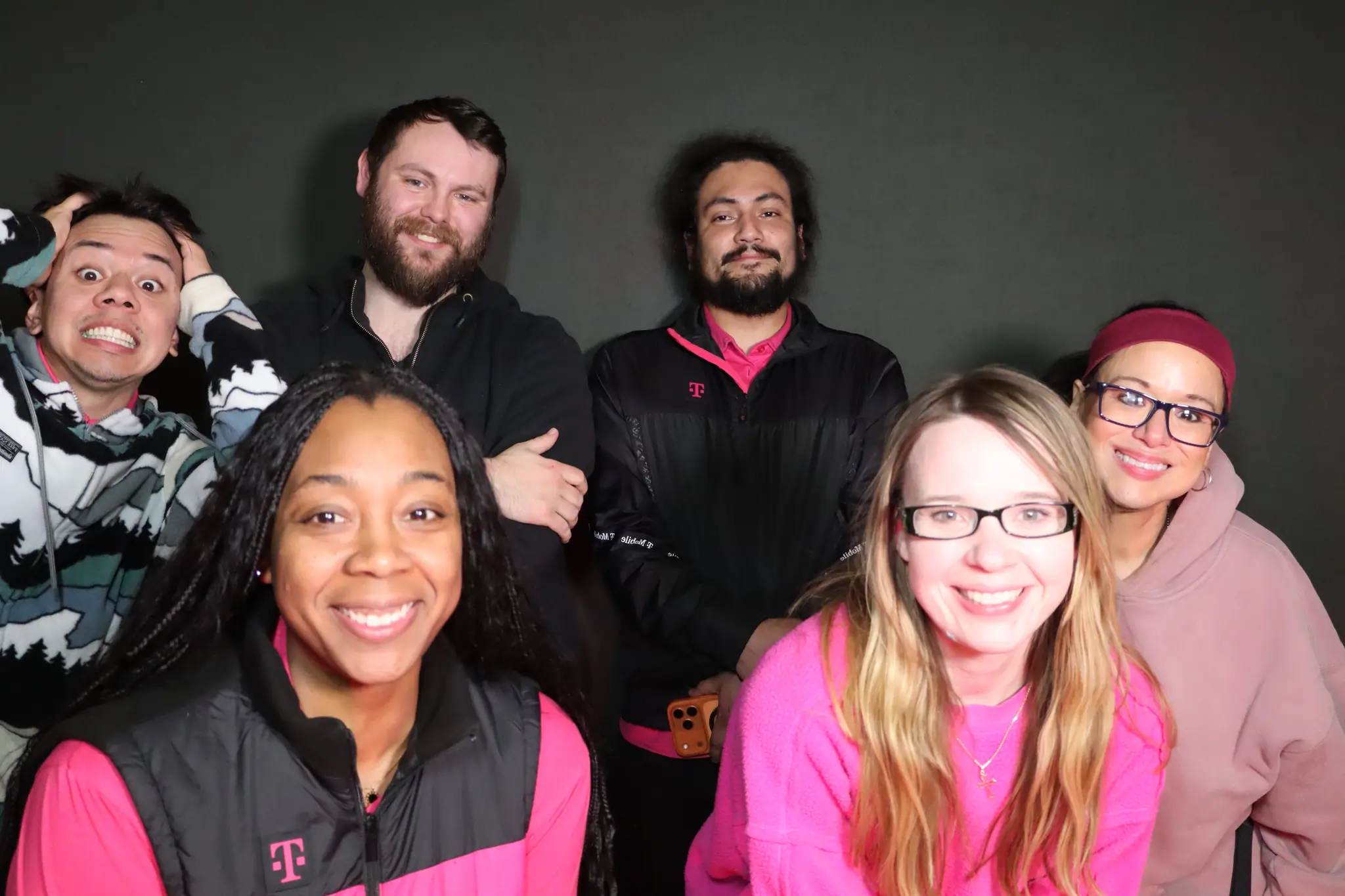 Corporate team celebrating together in the photo booth by Images & Creations
