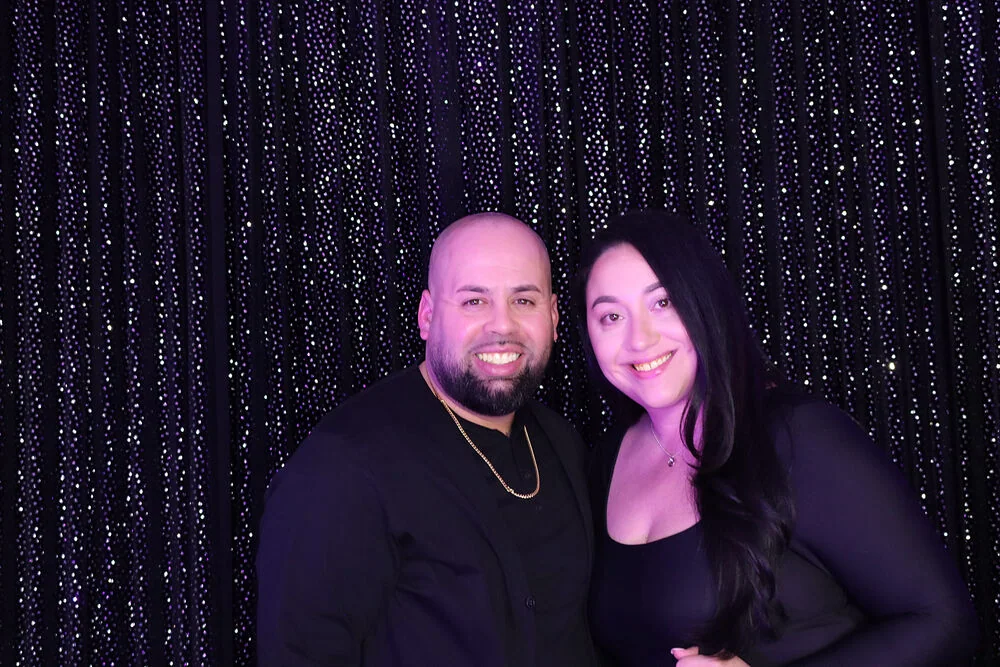 Two guests posing together in Jayla’s photo booth by Images & Creations