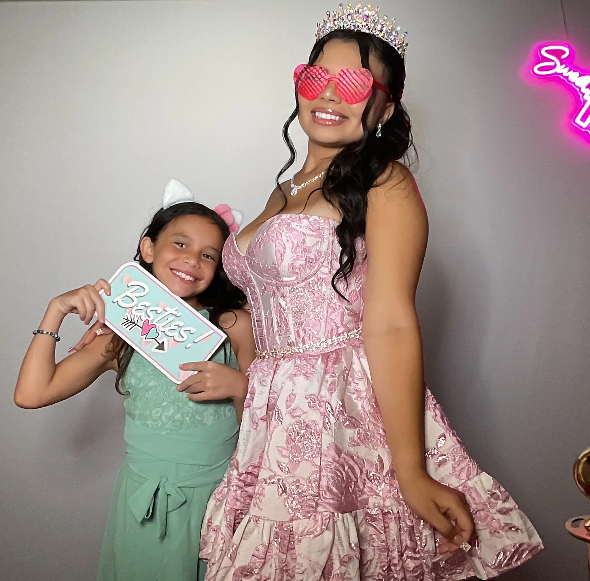 Maleah and a younger guest posing with a besties sign by Images & Creations