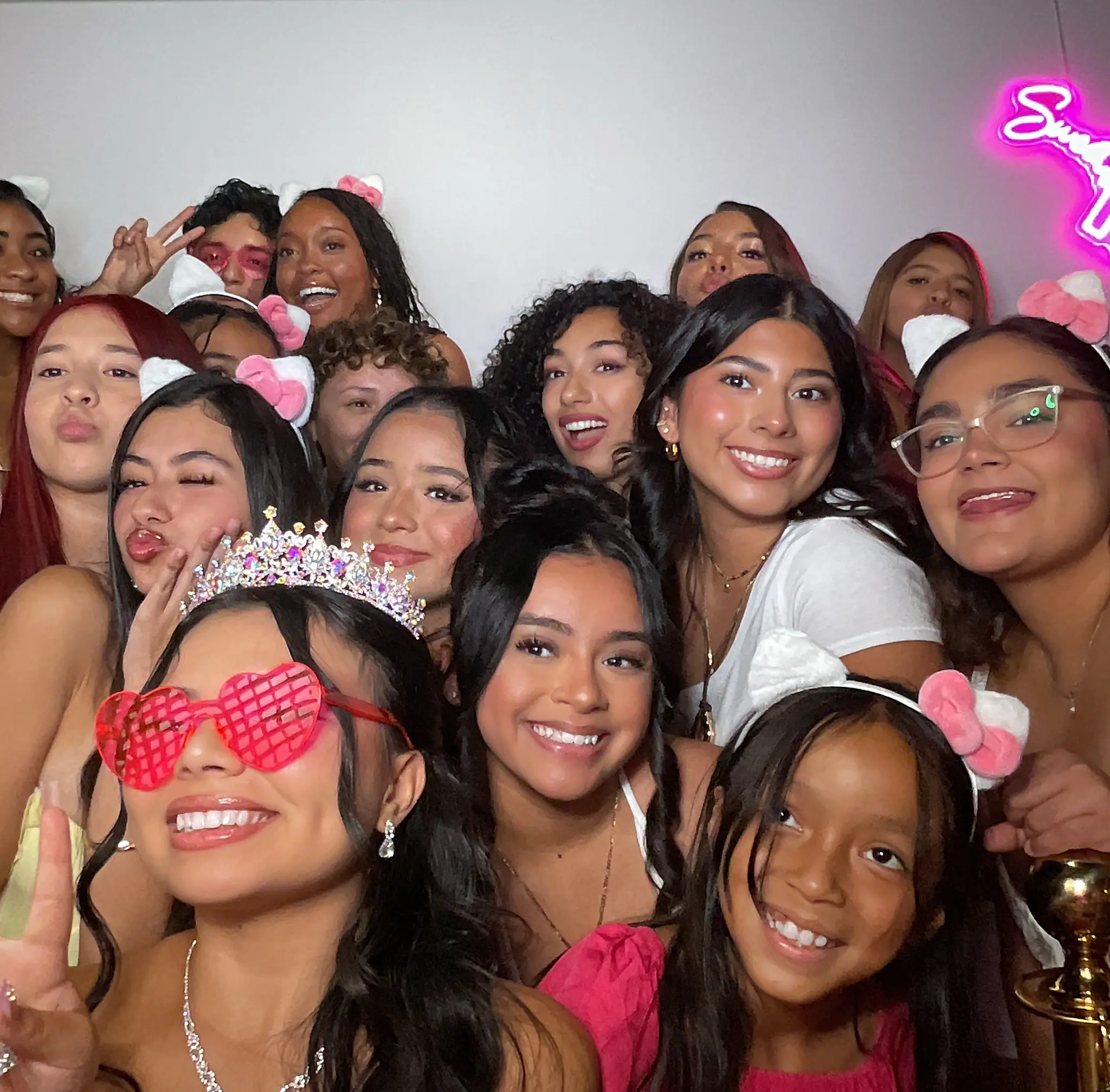 A large group of friends gathered around Maleah in the Vintage Booth by Images & Creations