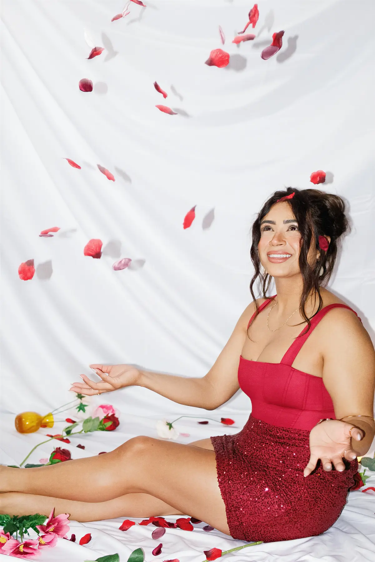 Creative portrait with falling rose petals