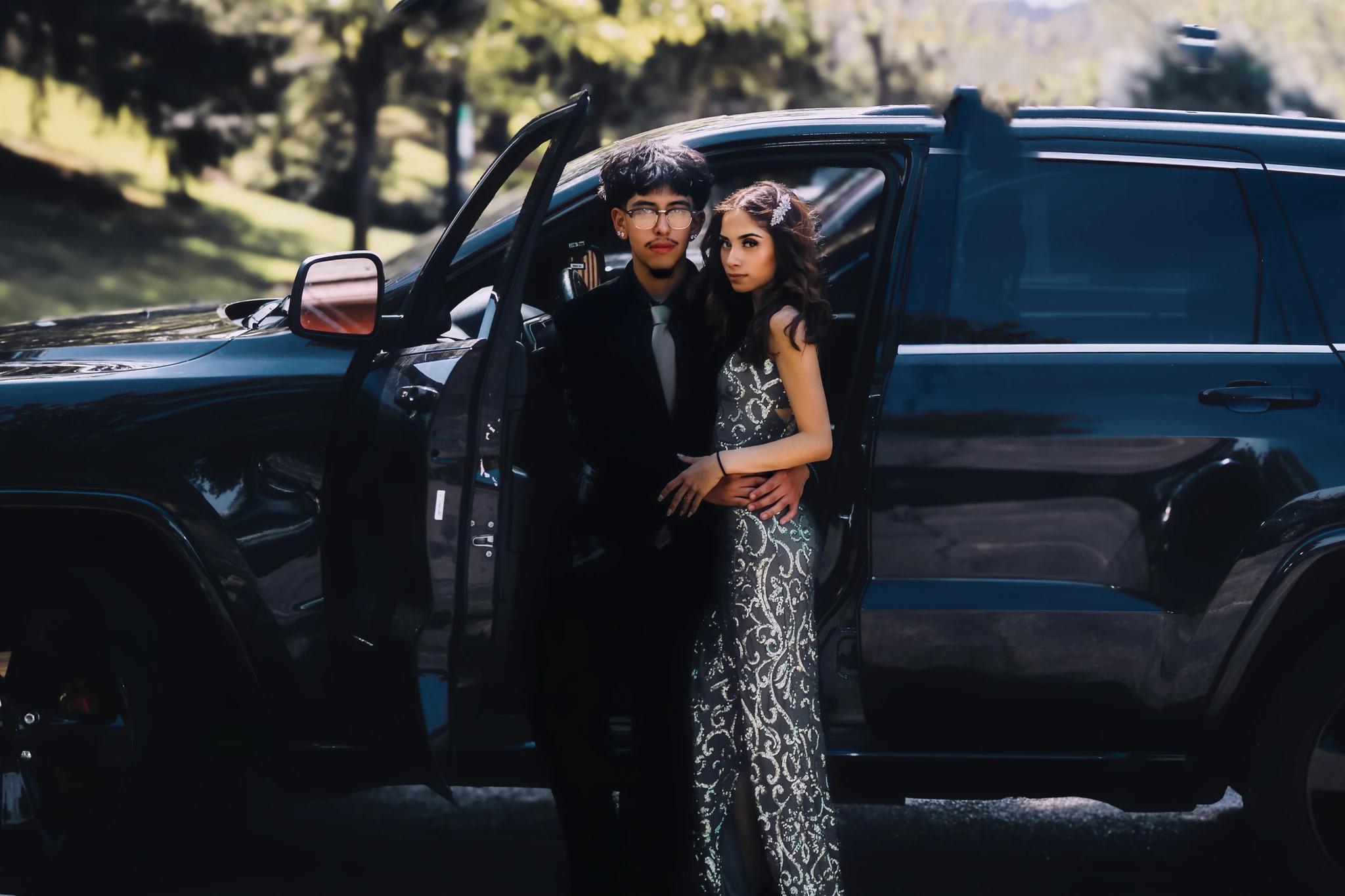 Prom couple photographed beside their arrival vehicle